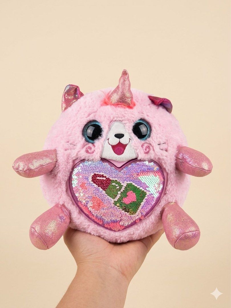 Rainbowcorn Pink Unicorn Cat Plush Toy with Sequins (Category: Plushies & Soft Toys) located in Baguio. Submitted by cherylcaps95 (Listing ID 1460510343, Image 1). Description: - Adorable pink plush toy - Features a round cat design - Adorned with a unicorn horn and butterfly wings - Front has a heart with reversible sequins - Sequins reveal lipstick and makeup designs - Made from soft and fluffy material - Ideal for children or toy collectors.