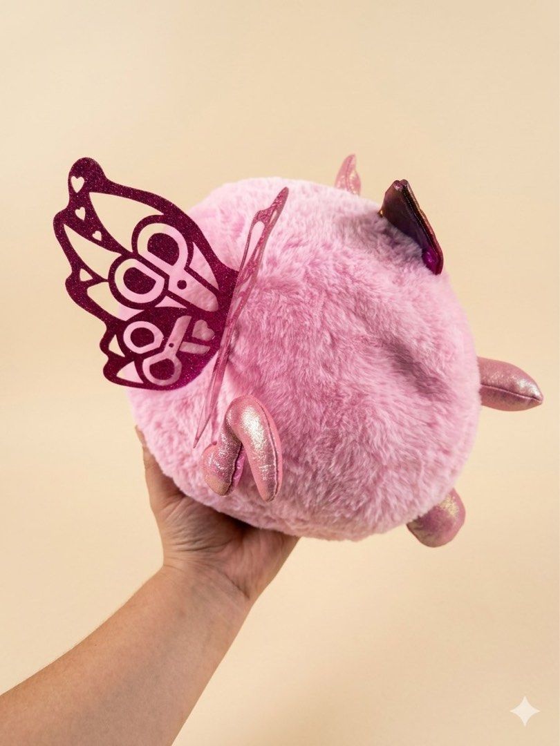 Rainbowcorn Pink Unicorn Cat Plush Toy with Sequins (Category: Plushies & Soft Toys) located in Baguio. Submitted by cherylcaps95 (Listing ID 1460510343, Image 2). Description: - Adorable pink plush toy - Features a round cat design - Adorned with a unicorn horn and butterfly wings - Front has a heart with reversible sequins - Sequins reveal lipstick and makeup designs - Made from soft and fluffy material - Ideal for children or toy collectors.