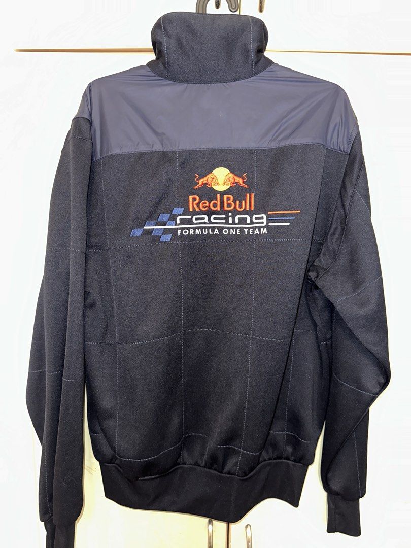 Red Bull Racing Formula 1 Team Track Jacket (Category: Coats, Jackets and Outerwear) located in Quezon City. Submitted by mancave_stuff (Listing ID 1460591951, Image 3). Description: - Classic Red Bull Racing jacket -Size M: W23” x L26” - Features team logo on front and back - Striped detail on the sides - Full zip closure for easy wear - Ribbed cuffs and hem for a snug fit - A must-have for any Formula 1 enthusiast.