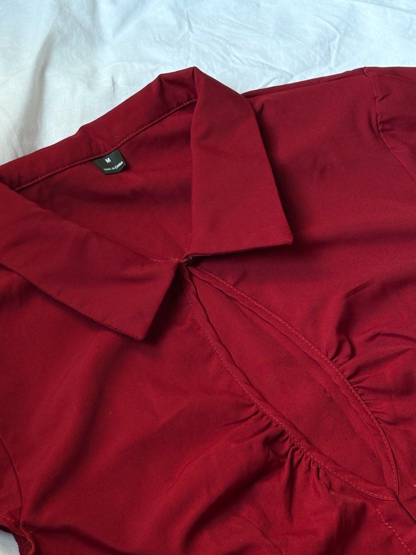 Red Collared Cap Sleeve Blouse with Hook-and-Eye Closure (Category: Blouses) located in Pasay City. Submitted by nicoletlntn_ (Listing ID 1460528933, Image 2). Description: - Red collared blouse - Short cap sleeves - Ruched detail at the bust - Hook-and-eye closure down the front - Vertical seams on the back for a fitted silhouette - Versatile for work or evening wear - Pairs well with skirts and pants.