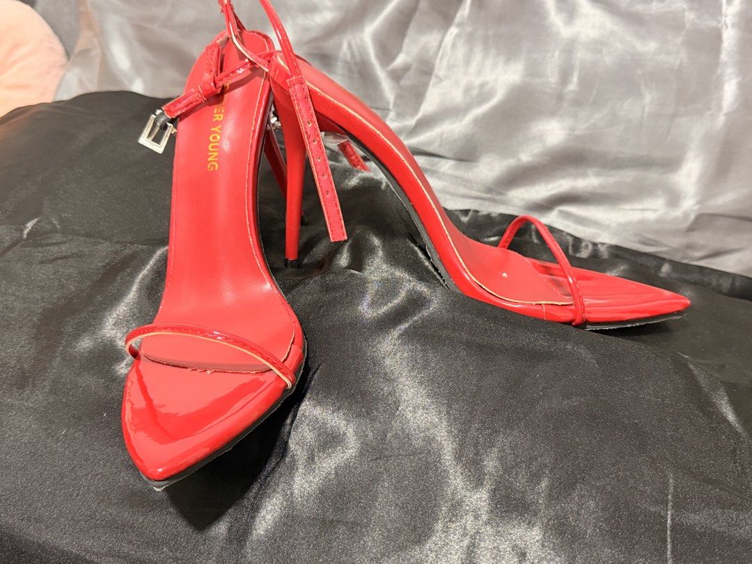 Red Strappy High Heels (Category: Heels) located in Mandaluyong City. Submitted by empresskie (Listing ID 1460685443, Image 1). Description: • Bright red patent finish • Thin strappy design • Ankle buckle closure • Pointed square toe • High stiletto heels • Size: 38 • Pre-loved — see photos for condition • Some signs of wear on the soles, but still very wearable.