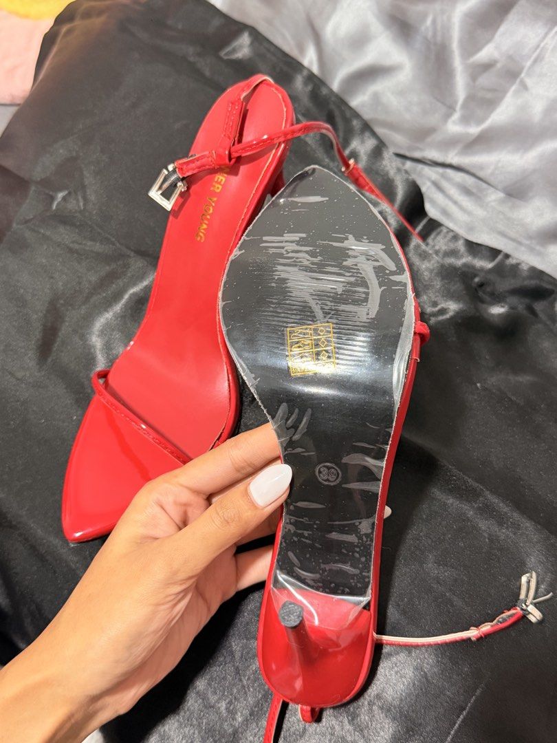 Red Strappy High Heels (Category: Heels) located in Mandaluyong City. Submitted by empresskie (Listing ID 1460685443, Image 2). Description: • Bright red patent finish • Thin strappy design • Ankle buckle closure • Pointed square toe • High stiletto heels • Size: 38 • Pre-loved — see photos for condition • Some signs of wear on the soles, but still very wearable.