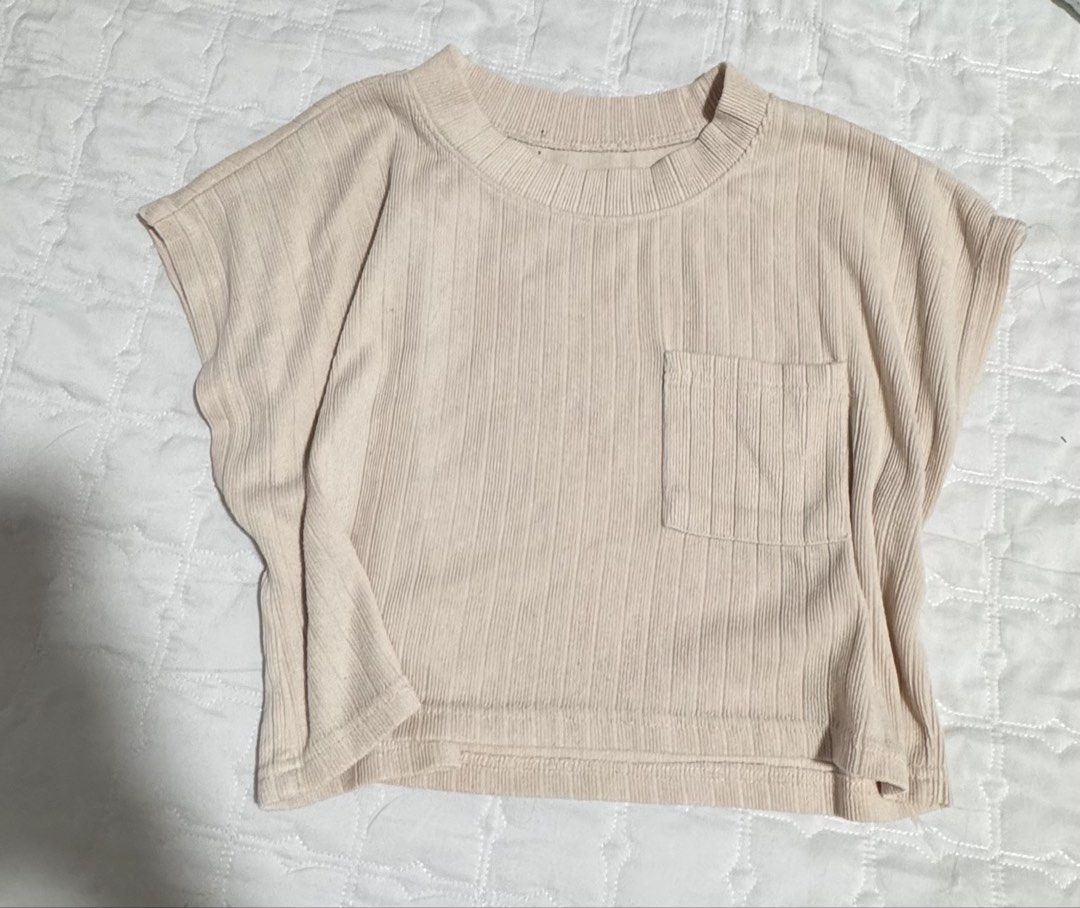 Ribbed T-shirt with Pocket (Category: Shirts) located in Manila. Submitted by wildlion_020304 (Listing ID 1460670848, Image 1). Description: - Cream colored ribbed t-shirt - Features a small pocket on the left chest - Short sleeves and crew neck design - Textured fabric for a comfortable feel - Perfect for everyday wear - Easily pairs with jeans or shorts.