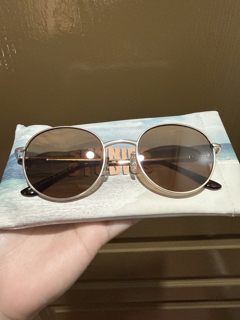 Round Sunglasses with Brown Lenses (Category: Sunglasses & Eyewear) located in Manila. Submitted by jdjapsalwa55047 (Listing ID 1460577085, Image 1). Description: Stylish round sunglasses with gold frame and brown lenses. Includes a beach-themed pouch. Perfect for sunny days!.