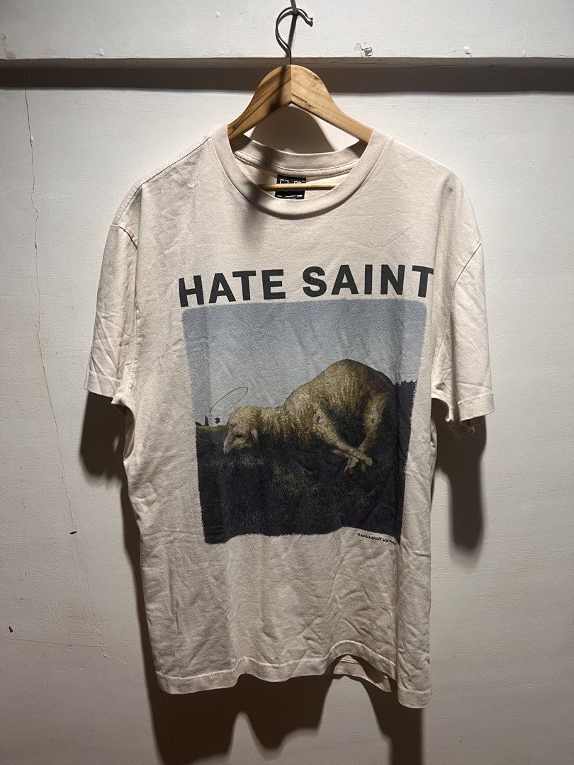 Saint Mxxxxxx Hate Sheep Tee White (Category: Tshirts & Polo Shirts ) located in San Juan, La Union. Submitted by jeggystyle (Listing ID 1460526494, Image 1). Description: - White Saint Mxxxxxx T-shirt - Unique front graphic: "HATE SAINT" with a sheep image - Unique back graphic: "LOVE SAINT ALWAYS" - Perfect for collectors - Versatile for any wardrobe.