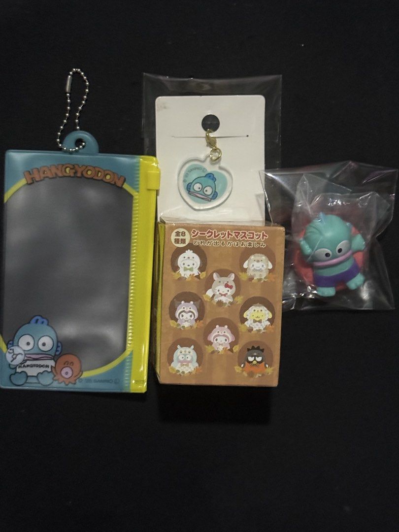 Sanrio Hangyodon Assorted Items (Category: Character Goods) located in Mandaluyong City. Submitted by myeonii.e (Listing ID 1460679065, Image 2). Description: Assorted Hangyodon Items! All brand new, only plushie with original box. Bundle Price: 450 Individual Prices: - Fastener Case (₱75, original price ₱98) - Acrylic Charm (₱50, original price ₱98) - Gacha Figure (₱195, original price ₱260) - Plush Charm (₱300, original price ₱650) Feel free to