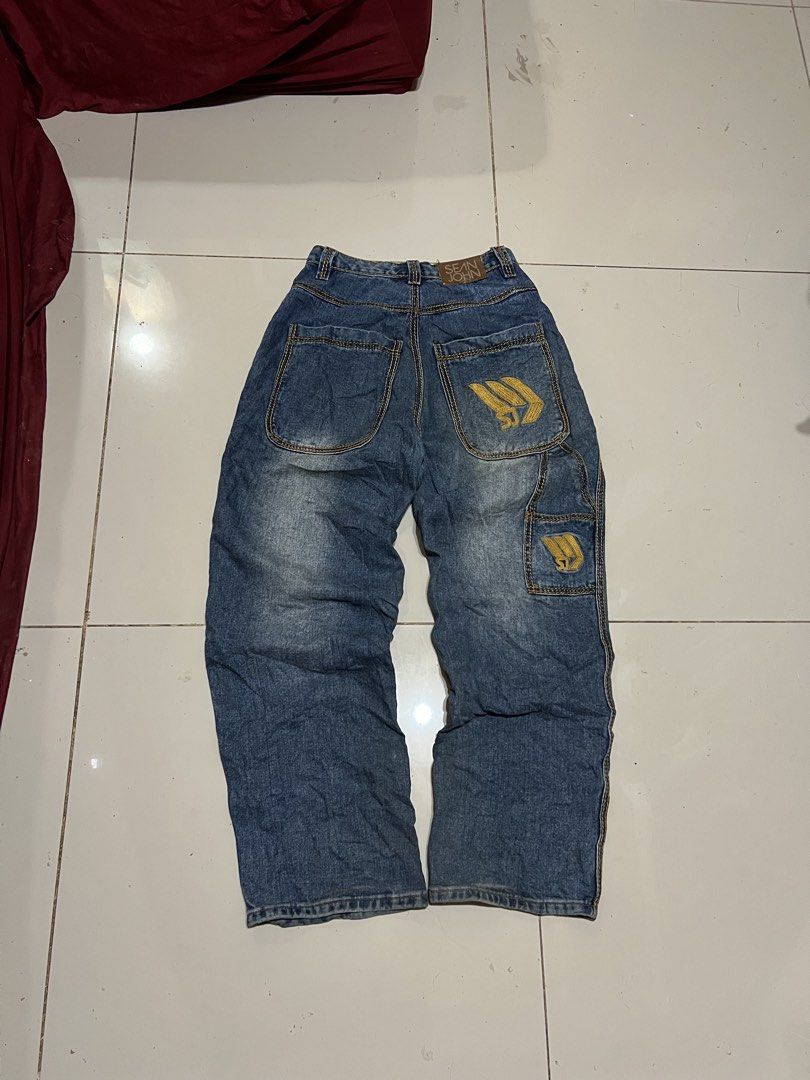 Sean John Denim Jeans Size 28 (Category: Jeans) located in Butuan. Submitted by nikthrift. (Listing ID 1460674241, Image 1). Description: - Sean John denim jeans - Classic blue wash with yellow stitching - Iconic SJ logo embroidered on back pocket - Smaller SJ logo on side cargo pocket - Size: 28 waist - Material: 100% Cotton - Ideal for a streetwear look - size 28 waistline - 39 length - 12.5 leg opening - 9 hem.