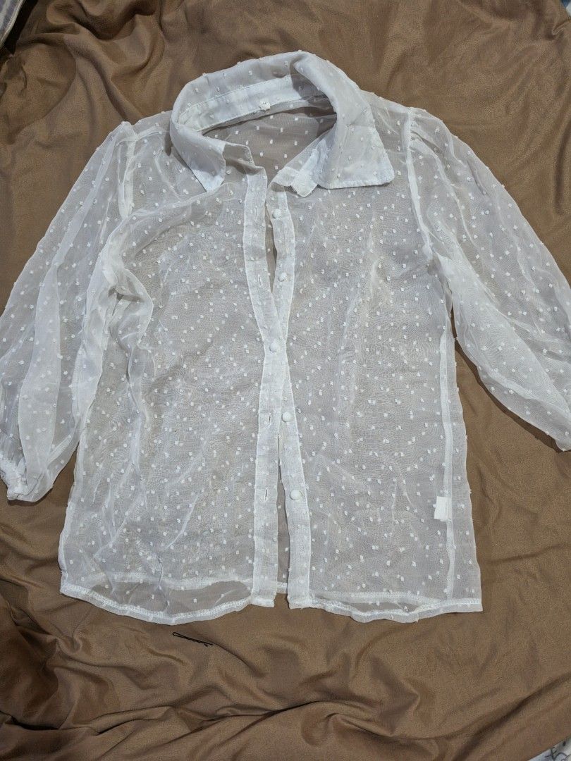 Sheer White Polka Dot Puff Sleeve Blouse (Category: Blouses) located in Malabon City. Submitted by lpzangie (Listing ID 1460602849, Image 1). Description: - White sheer blouse - Polka dot pattern - Puff sleeves - Button-up front - Collar neckline - Lightweight and airy fabric - Perfect for layering or wearing alone - Looks adorable with a camisole underneath.