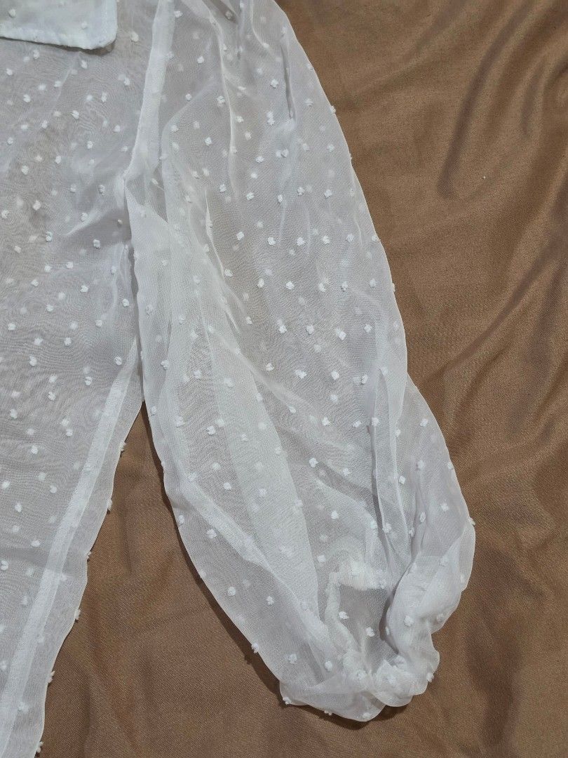 Sheer White Polka Dot Puff Sleeve Blouse (Category: Blouses) located in Malabon City. Submitted by lpzangie (Listing ID 1460602849, Image 3). Description: - White sheer blouse - Polka dot pattern - Puff sleeves - Button-up front - Collar neckline - Lightweight and airy fabric - Perfect for layering or wearing alone - Looks adorable with a camisole underneath.