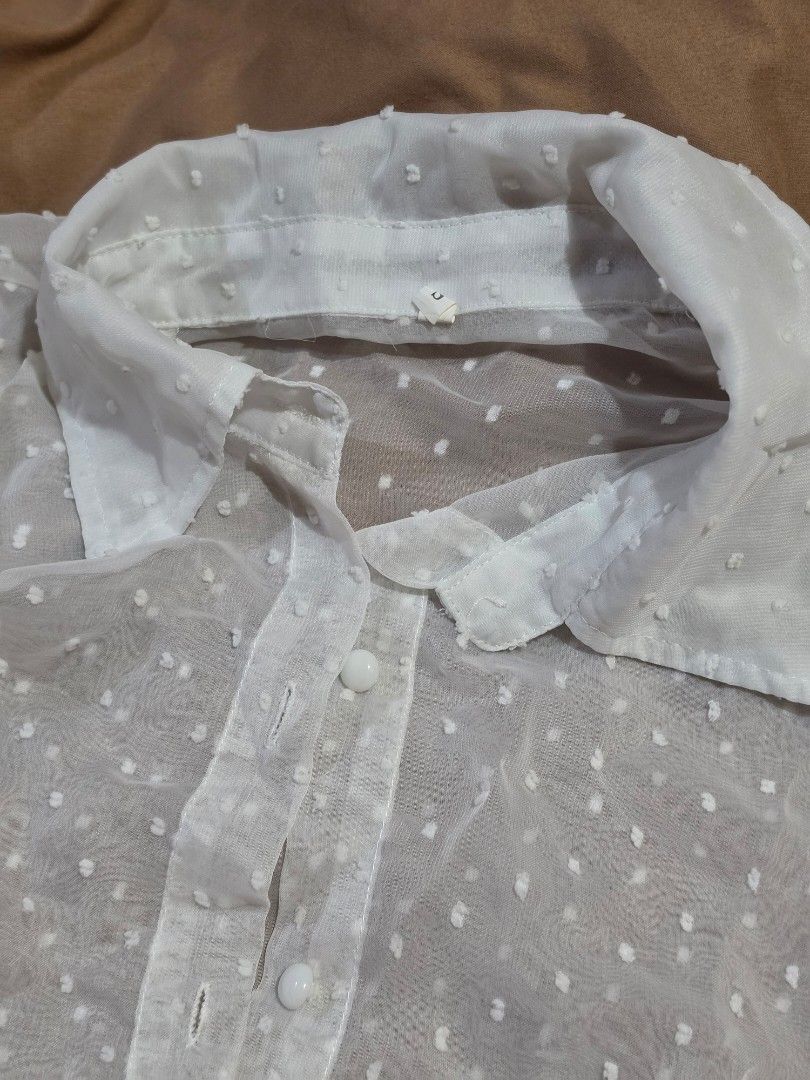 Sheer White Polka Dot Puff Sleeve Blouse (Category: Blouses) located in Malabon City. Submitted by lpzangie (Listing ID 1460602849, Image 2). Description: - White sheer blouse - Polka dot pattern - Puff sleeves - Button-up front - Collar neckline - Lightweight and airy fabric - Perfect for layering or wearing alone - Looks adorable with a camisole underneath.