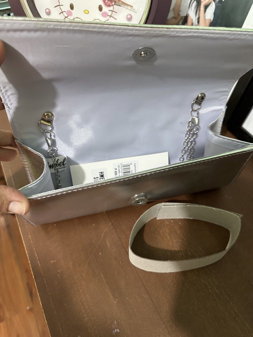 Silver Rhinestone Clutch Bag with Chain Strap (Category: Clutches) located in Quezon City. Submitted by joyful05 (Listing ID 1460536021, Image 2). Description: - Sparkly silver clutch bag - Covered in rhinestones with a geometric pattern - Comes with a silver chain strap - Can be used as a shoulder bag or clutch - Magnetic snap closure - Interior has a satin lining - Includes a detachable wrist strap - Perfect for wvening events, wedding.