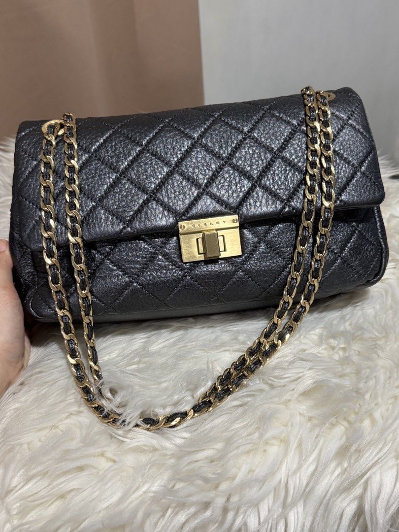 Sisley Chain Sling Bag (Category: Shoulder Bags) located in Marikina City. Submitted by welllovedbycarina (Listing ID 1460548180, Image 2). Description: Original Sisley, preowned from Korea Color in actual is metallic dark grey, ang unique ✨ The strap is convertible from shoulder to crossbody length Gold tone hardware Ready to ship from Marikina City Small size Dimensions: 29cm x 15cm x 7cm BAG CONDITION • Overall Condition: Excellent • Leather/M