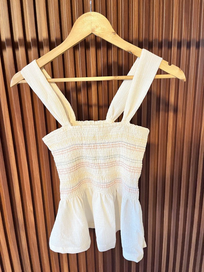 Smocked Peplum Top with Straps (Category: Sleeveless) located in Echague. Submitted by aeafitz (Listing ID 1460537933, Image 1). Description: - Cream colored smocked top - Thin straps - Peplum hem - Subtle colorful stitching details on smocked part - Textured fabric - Pairs well with jeans or shorts.