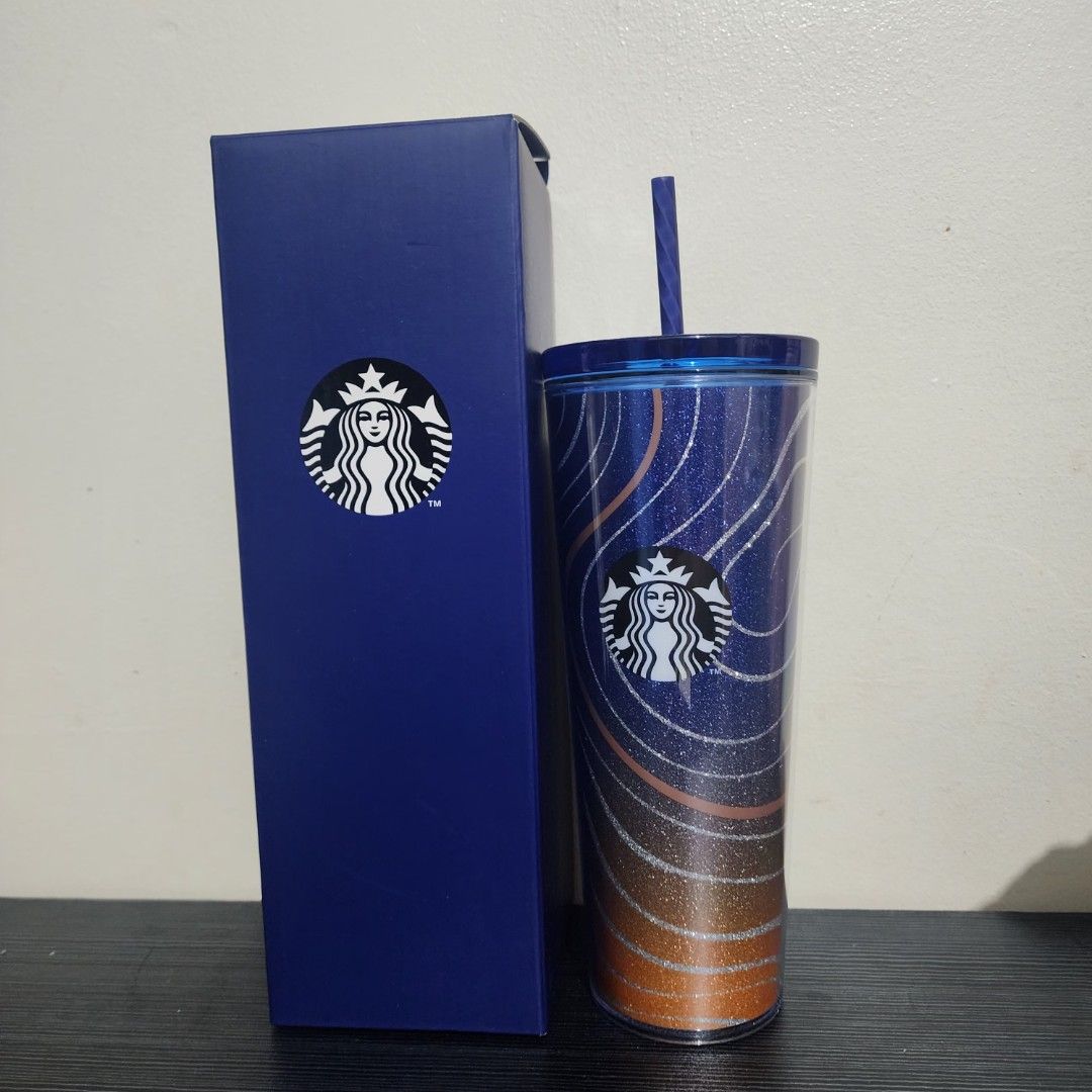 Starbucks 2025 Indigo Cold Cup (Category: Water Bottles & Tumblers) located in Pasig City. Submitted by devians_online_shop (Listing ID 1460581380, Image 1). Description: - Starbucks tumbler with straw - Cool blue and orange glittery design with wavy lines - Includes original blue Starbucks box - Ideal for your daily beverages.