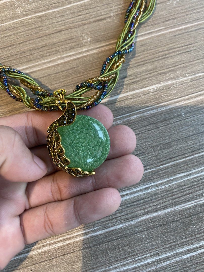 Statement/Chunky collar necklace (Category: Luxury Accessories) located in Manila. Submitted by ddxyatchang (Listing ID 1460534087, Image 1). Description: Statement / Chunky Collar Necklace Design Motif: Peacock pendant Centerpiece Stone: Light green round cabochon stone with a crackle/dragon vein texture (typically crackle agate, glass, or resin). Pendant Details: Antique gold-tone/bronze metal styled as a stylized peacock perched along the side
