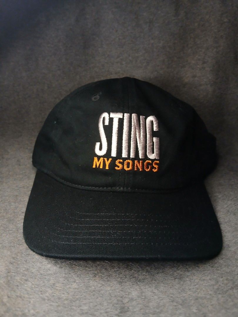 Sting My Songs Black Baseball Cap (Category: Caps & Hats) located in Caloocan City. Submitted by benthriftshp (Listing ID 1460682172, Image 1). Description: - Black baseball cap - Embroidered 'STING MY SONGS' on front - 'STING' text in white - 'MY SONGS' text in orange - Adjustable strap for a comfortable fit - Ideal for Sting fans and band merchandise collectors adult size 500+sf.