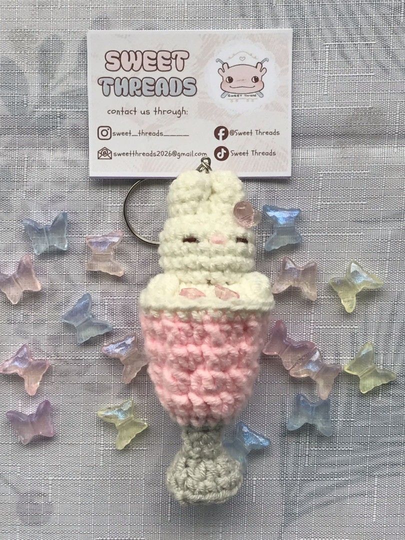 Sweet Threads Crochet Bunny Drink Keychain (Category: Handmade Craft) located in Rizal. Submitted by gentlebear-6e31 (Listing ID 1460712461, Image 1). Description: -meet up pwede sa Rizal montalban manila hills or caloocan MCU - Handmade crochet keychain - Features a cute bunny inside a drink cup - Design: White bunny top, pink drink body, grey base - Adorned with small pink gems - Perfect accessory for bags or keys - Includes a durable metal key