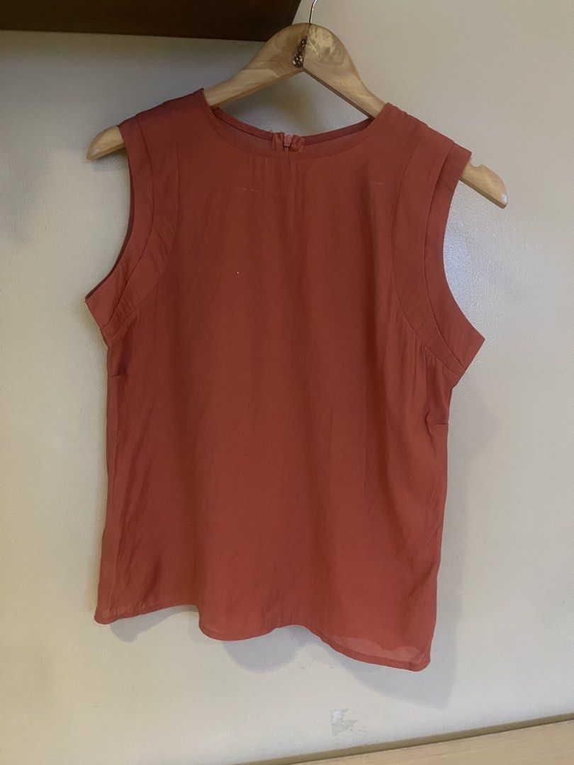 Terracotta short sleeve top (Category: Sleeveless) located in Quezon City. Submitted by booktt (Listing ID 1460651523, Image 3). Description: terracotta-colored sleeveless blouse featuring clean, structured seaming along the shoulders.