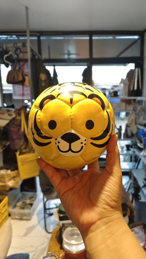 Tiger Face Soccer Ball (Category: Racket and Ball Sports) located in Bulacan. Submitted by babz30261 (Listing ID 1460637448, Image 1). Description: - Adorable tiger face design - Bright yellow with classic black stripes - Ideal for kids' play or as a fun decoration - Standard youth ball size - Looking for a new home!.