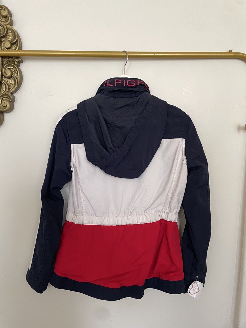Tommy Hilfiger Colorblock Hooded Jacket (Category: Coats, Jackets and Outerwear) located in Makati City. Submitted by alyslittlelamb (Listing ID 1460658185, Image 2). Description: - Classic Tommy Hilfiger colorblock jacket - Features navy, white, and red design - Includes a stowaway hood - Elasticated waist for a comfortable fit - Ideal for casual outings or light outdoor activities - Full front zipper closure.