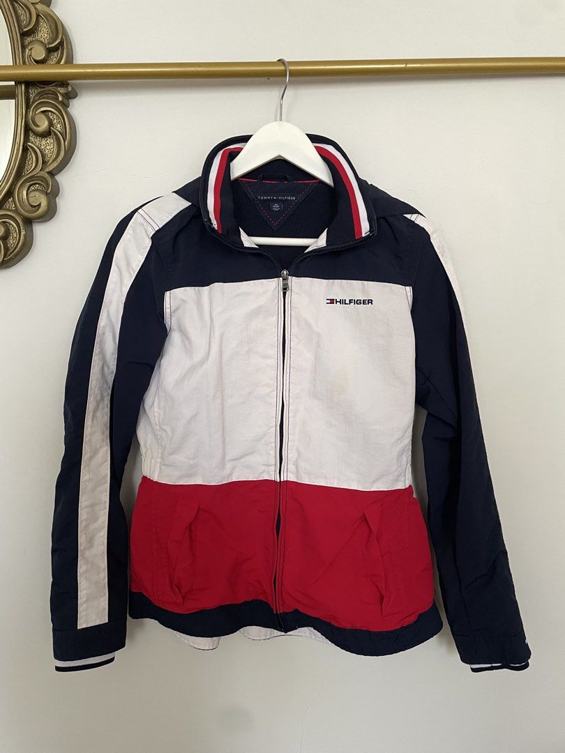Tommy Hilfiger Colorblock Hooded Jacket (Category: Coats, Jackets and Outerwear) located in Makati City. Submitted by alyslittlelamb (Listing ID 1460658185, Image 1). Description: - Classic Tommy Hilfiger colorblock jacket - Features navy, white, and red design - Includes a stowaway hood - Elasticated waist for a comfortable fit - Ideal for casual outings or light outdoor activities - Full front zipper closure.