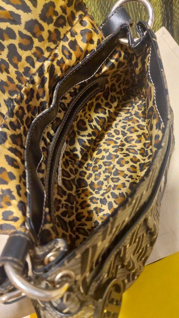 Tommy Hilfiger Monogram Shoulder Bag (Category: Shoulder Bags) located in Paranaque City. Submitted by daddyu (Listing ID 1460598495, Image 3). Description: - Vintage Authentic Tommy Hilfiger shoulder bag - Classic brown and black TH monogram pattern - Fun leopard print interior lining - Secure front flap clasp closure - Spacious interior for essentials - Perfect stylish everyday bag.