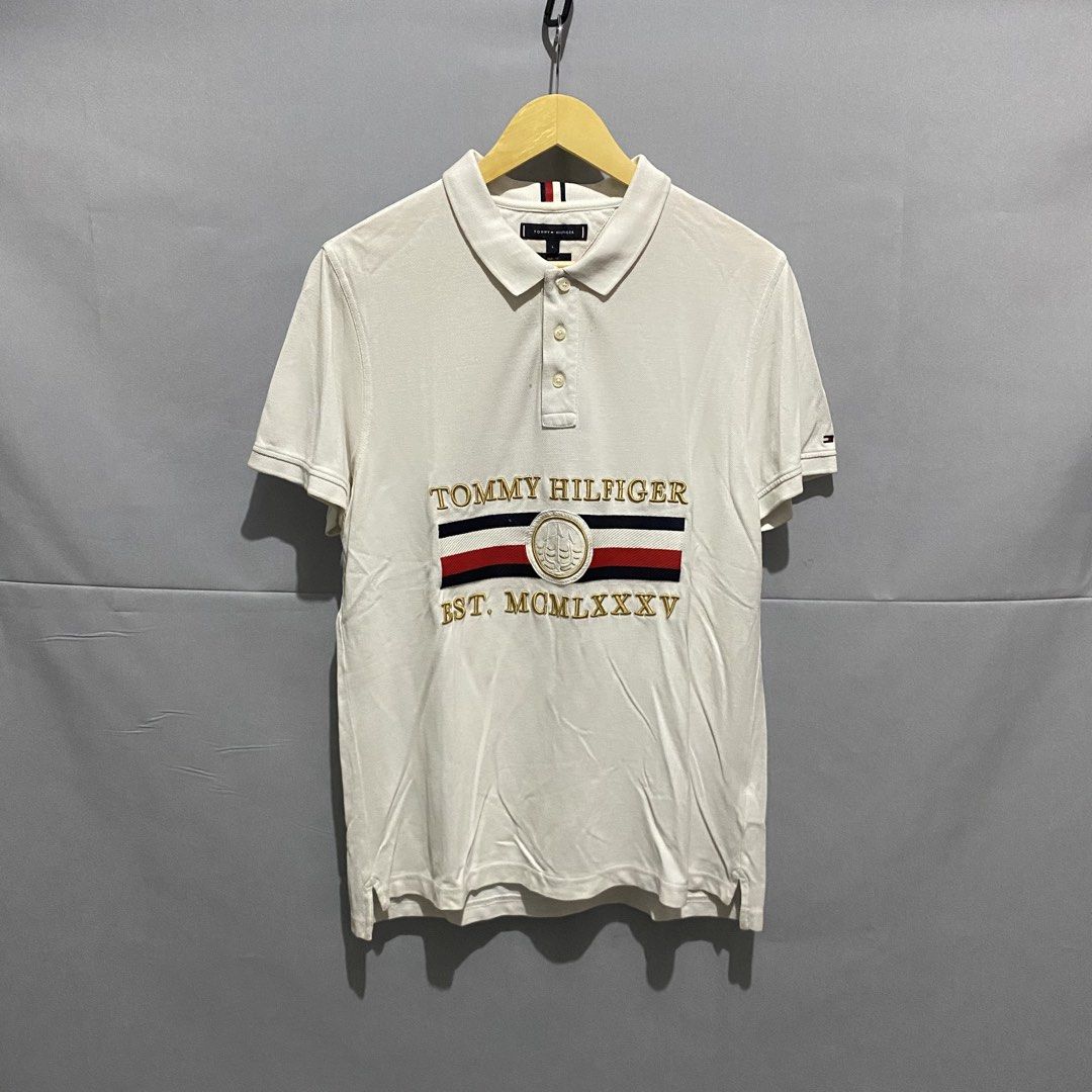 Tommy Holfiger (Category: Coats, Jackets and Outerwear) located in Baguio. Submitted by loc_bc (Listing ID 1460708364, Image 1). Description: Tommy Hilfiger Icons Nautical Embroidery Slim Fit Polo featuring a distinctive retro brand graphic across the chest.