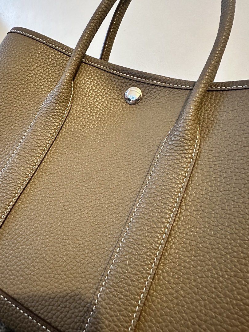 Tote Bag - Pebbled Leather, Taupe (Category: Tote Bags) located in Manila. Submitted by seej0991 (Listing ID 1460593653, Image 2). Description: - Classic tote bag style - Genuine Cowhide Leather - Central snap closure - Interior zippered pocket - Herringbone patterned lining - Ideal everyday bag - Garden Party - Inspired Tote Bag - Price Negotiable - Newly Purchased (2 Week old) - Complete with Dust Bag.