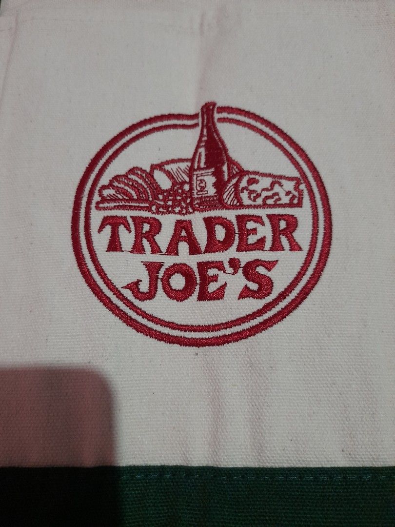 Trader Joe's Reusable Tote Bag (Category: Tote Bags) located in General Trias. Submitted by newberg0211 (Listing ID 1460656882, Image 2). Description: - Classic white and green Trader Joe's reusable tote bag - Material: 65% cotton, 35% polyester - Versatile use: groceries, beach trips, book bag - Care instructions: Machine wash cold, lay flat to dry - Note: May shrink slightly if machine dried - Imported from Vietnam.