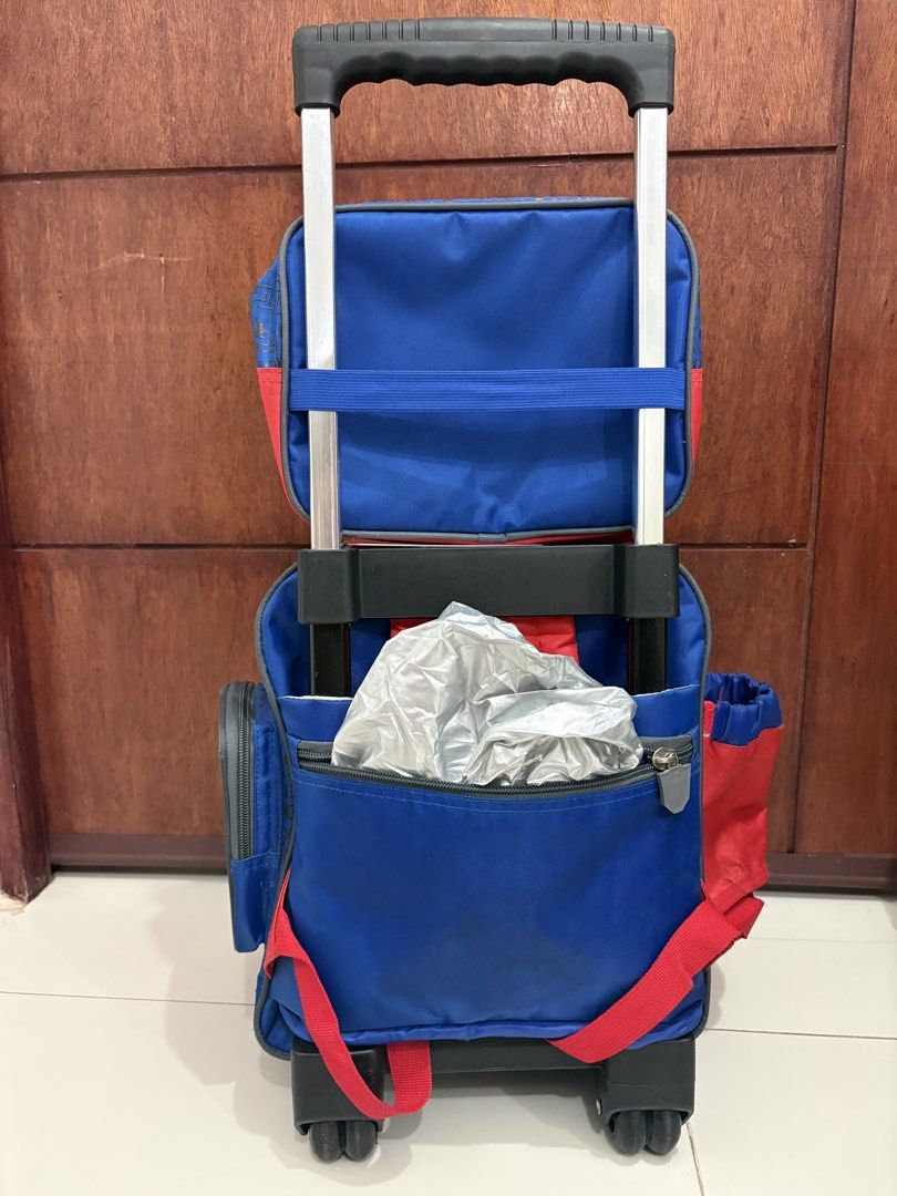 Transformers Rolling Backpack with Lunch Bag (Category: Backpacks) located in Manila. Submitted by kdp202 (Listing ID 1460639579, Image 3). Description: - Features cool Optimus Prime and Bumblebee graphics. - Includes a detachable lunch bag with the Autobot logo. - Stylish blue and red design with a Transformers pattern. - Ideal for school or travel. - Easy to pull with wheels and an extendable handle..