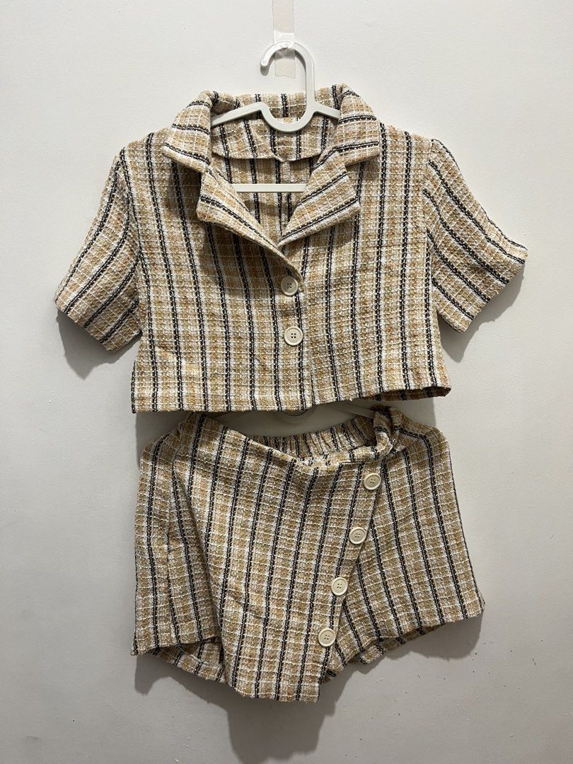 Tweed Crop Top and Shorts Set (Category: Sets or Coordinates) located in Manila. Submitted by jonalainea95245 (Listing ID 1460707840, Image 1). Description: - Cute tweed set - Classic beige, black, and white plaid pattern - Cropped button-up top - Wrap-style shorts with unique button closure Dimensions Top: Width - 39 cm, Length - 39 cm Bottom: Waist - 27 cm, Length - 39 cm RFS: di na nasusuot. worn twice only. Location: Malabon Delivery: J&T, La