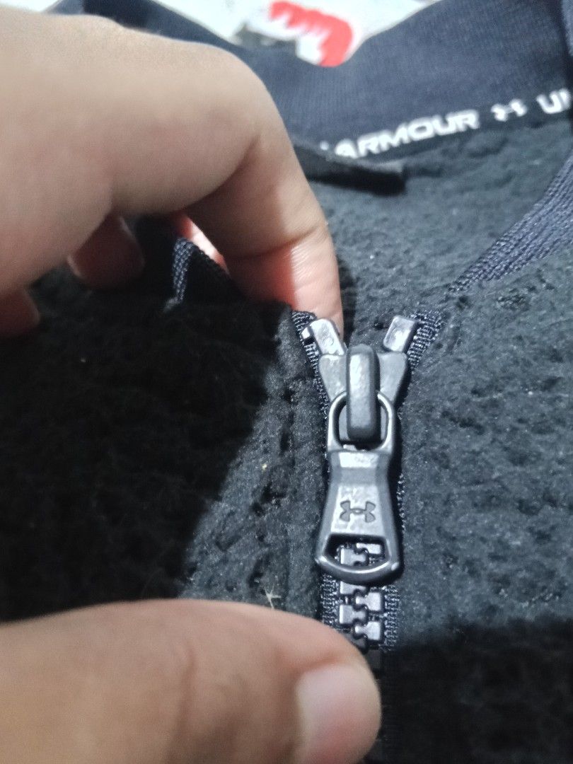 Under Armour Black Fleece Bomber Jacket (Category: Coats, Jackets and Outerwear) located in Lingayen. Submitted by rahzzelula73279 (Listing ID 1460668285, Image 3). Description: - Black Under Armour Fleece Bomber Jacket - Full zip closure - Ribbed collar and cuffs - Two front pockets - Made in the Philippines - Body: 100% Polyester - Overlays: 87% Polyester, 13% Elastane - Perfect for layering.