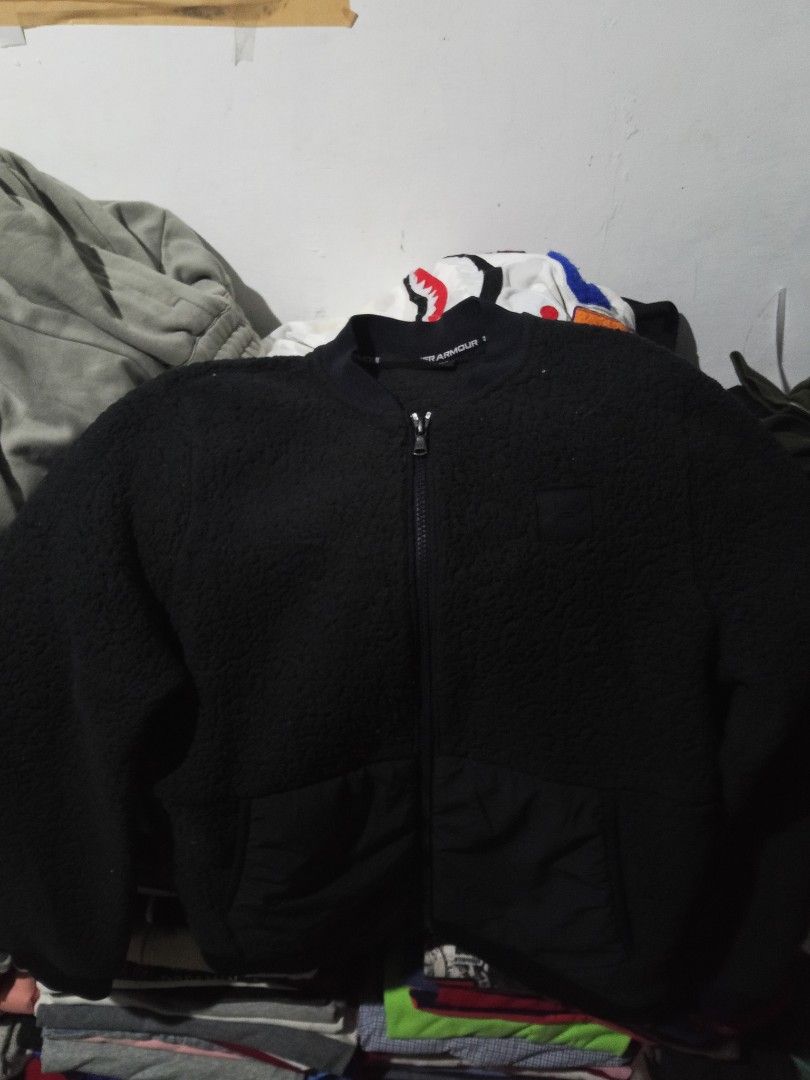 Under Armour Black Fleece Bomber Jacket (Category: Coats, Jackets and Outerwear) located in Lingayen. Submitted by rahzzelula73279 (Listing ID 1460668285, Image 1). Description: - Black Under Armour Fleece Bomber Jacket - Full zip closure - Ribbed collar and cuffs - Two front pockets - Made in the Philippines - Body: 100% Polyester - Overlays: 87% Polyester, 13% Elastane - Perfect for layering.