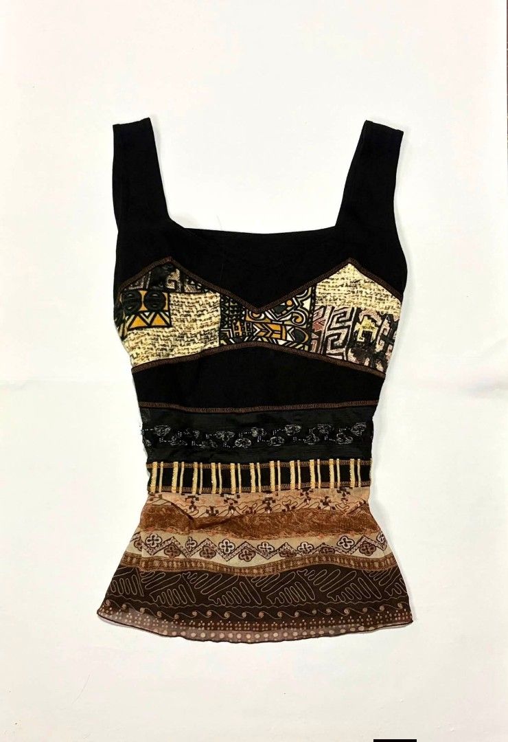 Unique Patchwork Tank Top with Tribal Print (Category: Sleeveless) located in Quezon City. Submitted by fairy_luna (Listing ID 1460662236, Image 1). Description: - Unique black tank top with a statement patchwork design. - Features tribal-inspired prints in beige and brown. - Sheer overlay at the bottom with additional patterned details. - Wide straps for a comfortable and stylish fit. - Perfect for creating a bold and eye-catching look..