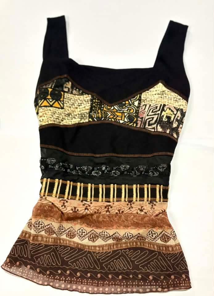 Unique Patchwork Tank Top with Tribal Print (Category: Sleeveless) located in Quezon City. Submitted by fairy_luna (Listing ID 1460662236, Image 2). Description: - Unique black tank top with a statement patchwork design. - Features tribal-inspired prints in beige and brown. - Sheer overlay at the bottom with additional patterned details. - Wide straps for a comfortable and stylish fit. - Perfect for creating a bold and eye-catching look..
