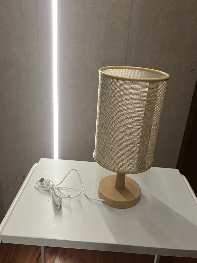 USB Table Lamp with Fabric Shade (Category: Lighting) located in Manila. Submitted by mxinii (Listing ID 1460620579, Image 1). Description: - Simple and stylish bedside lamp - Features a soft fabric shade - Convenient USB power cord with inline switch - Light tan colored base - Includes energy-efficient LED bulb - Ideal size for small desks or nightstands - Easy to turn on and off.