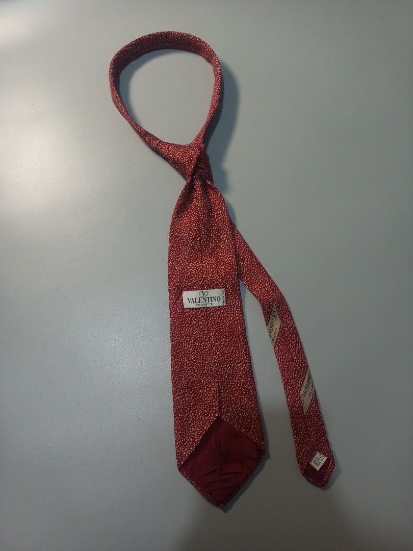 Valentino Red Patterned Silk Tie (Category: Ties) located in Calamba. Submitted by closet_from_the_past (Listing ID 1460618025, Image 1). Description: - Authentic Valentino tie - Luxurious silk material - Classic red color with a subtle all-over pattern - Elevates any outfit - Timeless design.