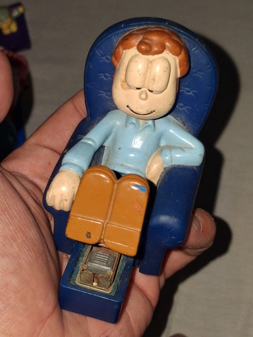 Vintage Garfield Desk Stapler Toy (Category: Vintage Collectibles) located in Manila. Submitted by marcas022798212 (Listing ID 1460623314, Image 3). Description: - Adorable Garfield stapler sitting on a blue chair. - Stapler mechanism is cleverly integrated into his legs. - Made in China. - Shows some signs of wear due to previous use. - A must-have for any Garfield enthusiast or collector!.