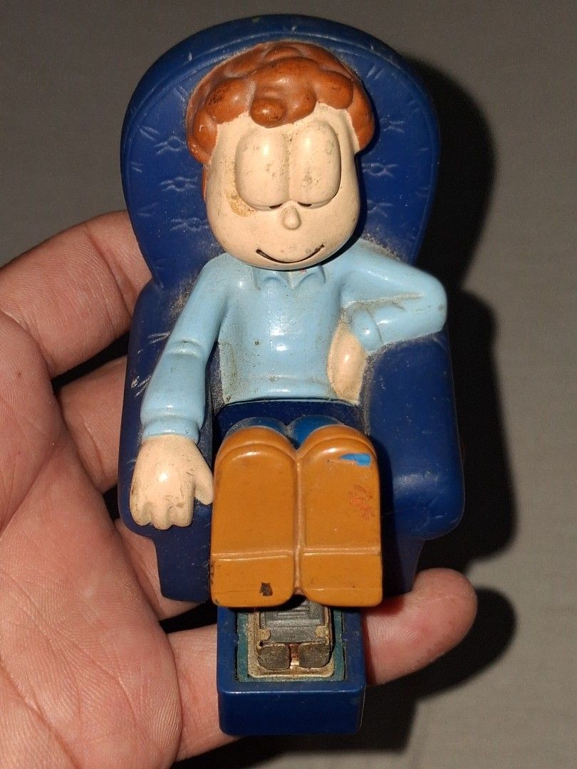 Vintage Garfield Desk Stapler Toy (Category: Vintage Collectibles) located in Manila. Submitted by marcas022798212 (Listing ID 1460623314, Image 1). Description: - Adorable Garfield stapler sitting on a blue chair. - Stapler mechanism is cleverly integrated into his legs. - Made in China. - Shows some signs of wear due to previous use. - A must-have for any Garfield enthusiast or collector!.