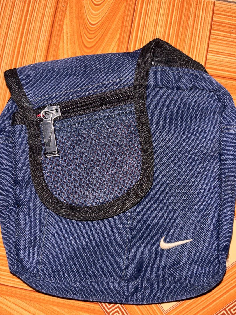 Vintage Nike Sling bag (Category: Sling Bags) located in Polomolok. Submitted by rrthrift (Listing ID 1460665636, Image 2). Description: Vintage Nike Sling bag - Navy blue Nike crossbody bag - Front zip pocket with mesh overlay - Main compartment with zipper closure - Adjustable strap for comfortable wear - Compact and convenient for carrying essentials - Ideal for everyday use 599+sf.