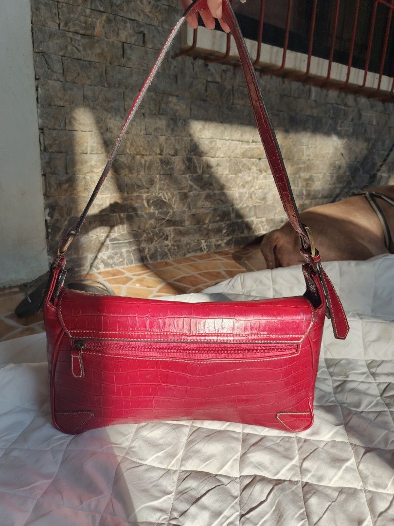 Vivace Red Croc Embossed Shoulder Bag (Category: Shoulder Bags) located in Cebu City. Submitted by vionchan (Listing ID 1460606300, Image 3). Description: - Stylish red shoulder bag with a sophisticated croc-embossed texture. - Main zippered compartment for secure storage. - Convenient back zippered pocket for quick access. - Elegant gold-tone hardware details. - Adjustable strap with buckle for a customized fit. - Ideal for everyday use, adding 