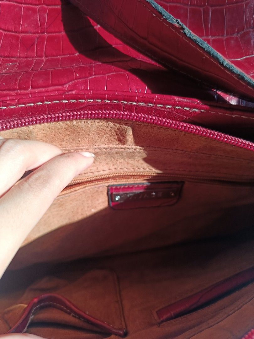 Vivace Red Croc Embossed Shoulder Bag (Category: Shoulder Bags) located in Cebu City. Submitted by vionchan (Listing ID 1460606300, Image 2). Description: - Stylish red shoulder bag with a sophisticated croc-embossed texture. - Main zippered compartment for secure storage. - Convenient back zippered pocket for quick access. - Elegant gold-tone hardware details. - Adjustable strap with buckle for a customized fit. - Ideal for everyday use, adding 