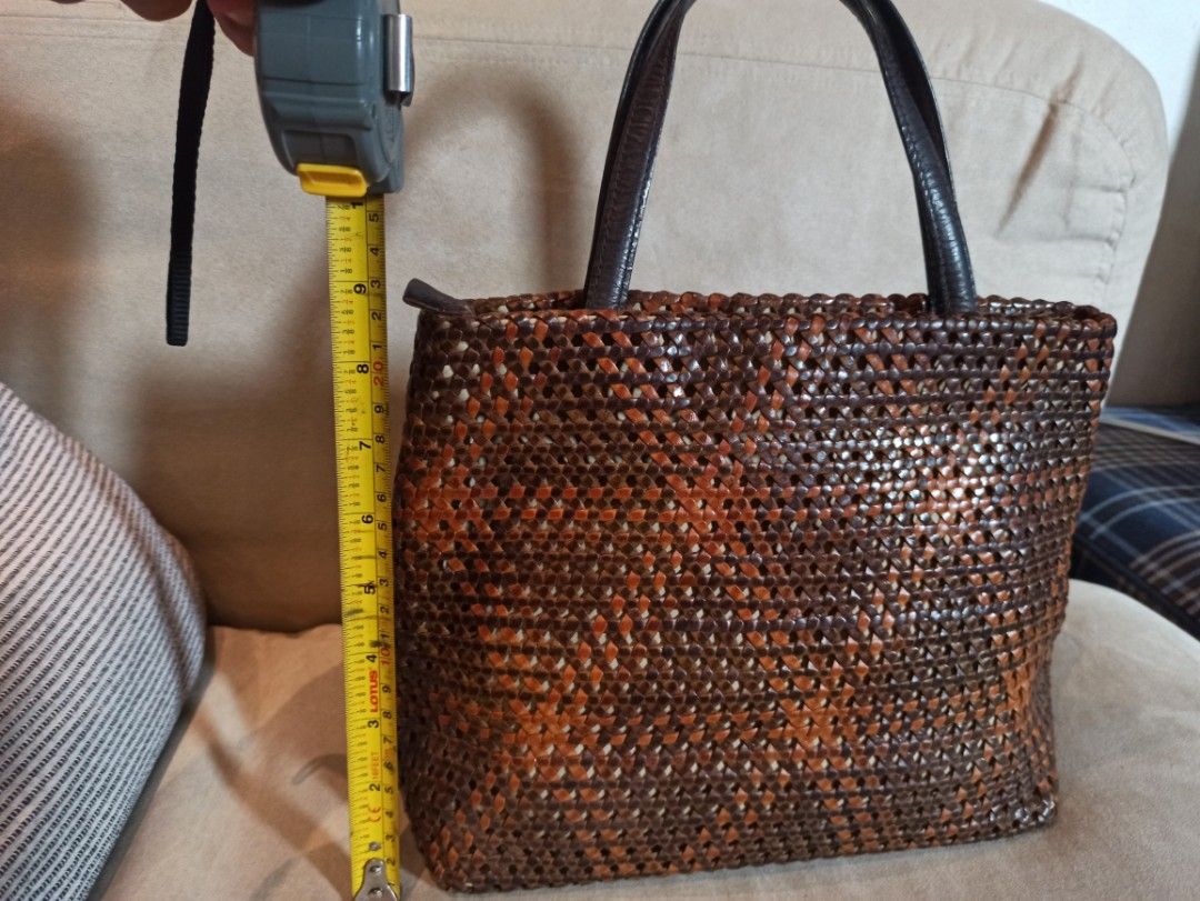 Vogline Woven Genuine Leather Handbag (Category: Luxury Bags & Wallets) located in Caloocan City. Submitted by rtarellano (Listing ID 1460546071, Image 1). Description: - Stylish woven Genuine leather handbag - Rich mix of brown and orange tones in the weave - Comfortable dark brown leather handles - Smooth satin interior lining - Convenient interior zippered pocket - Secure zipper closure at the top - Approximate dimensions: 10" (height) x 8" (w
