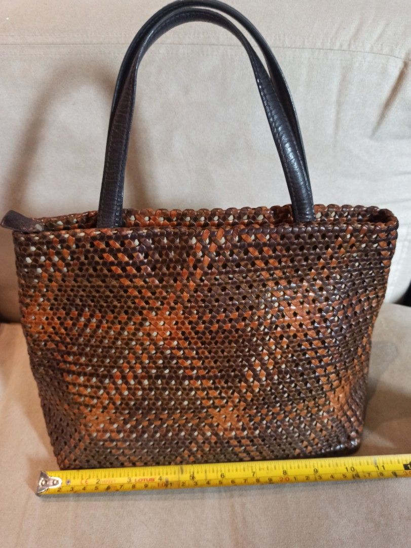 Vogline Woven Genuine Leather Handbag (Category: Luxury Bags & Wallets) located in Caloocan City. Submitted by rtarellano (Listing ID 1460546071, Image 2). Description: - Stylish woven Genuine leather handbag - Rich mix of brown and orange tones in the weave - Comfortable dark brown leather handles - Smooth satin interior lining - Convenient interior zippered pocket - Secure zipper closure at the top - Approximate dimensions: 10" (height) x 8" (w