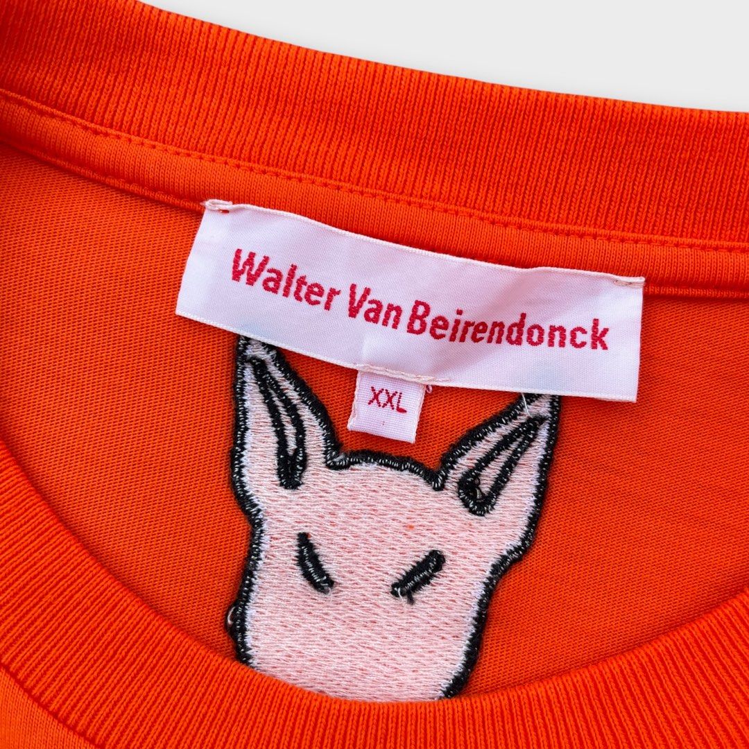 Walter Van Beirendonck - Past Present Future Shirt (Category: Tshirts & Polo Shirts ) located in Los Banos. Submitted by declutterking (Listing ID 1460703743, Image 3). Description: Size XXL on tag Walter's classic characters printed and embroidered on an orange cotton t-shirt. Walterman logo tag on the side left seam. Dimensions: 18.75" shoulders 23.25" chest 30" length 8.75" sleeves Good as new condition Authentic.