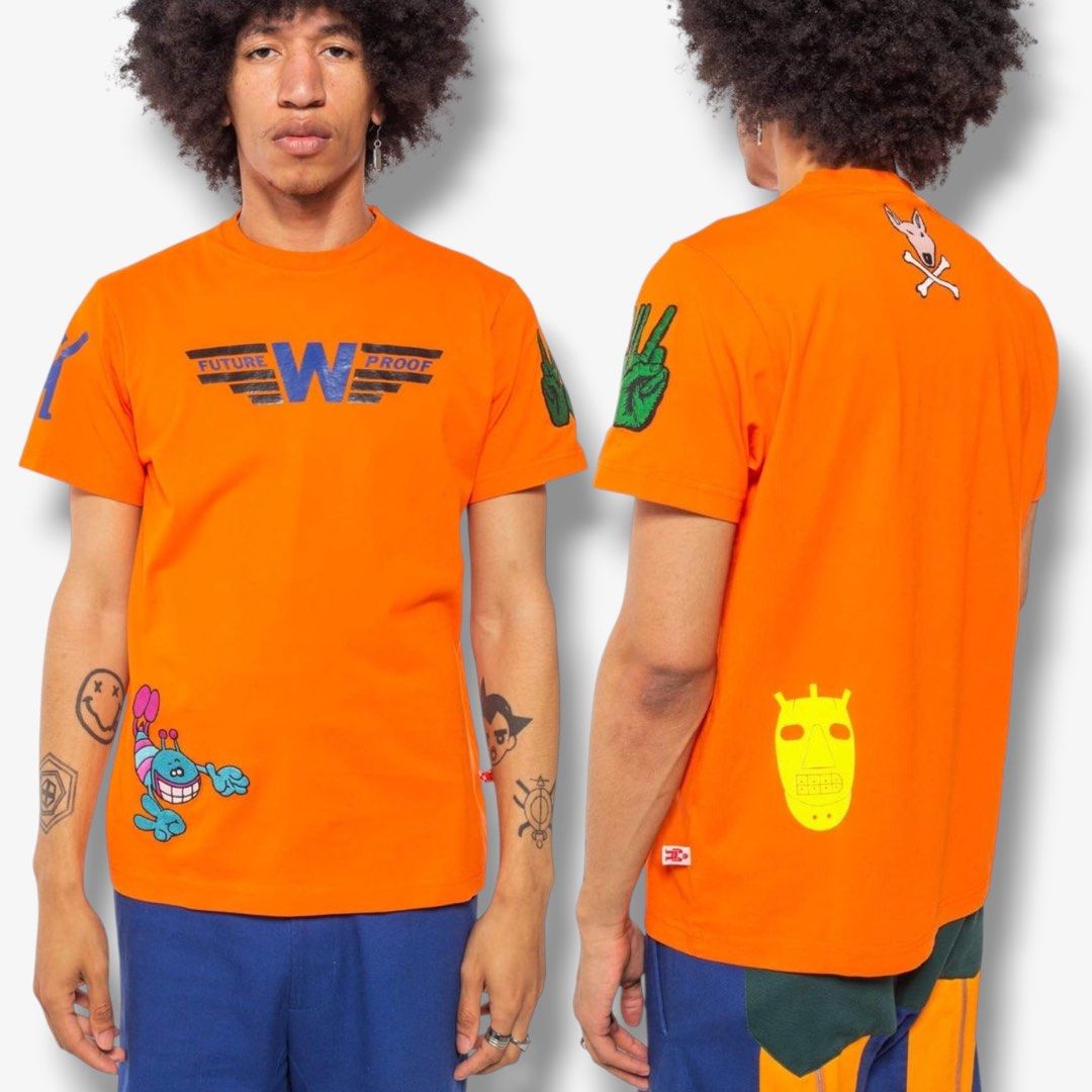 Walter Van Beirendonck - Past Present Future Shirt (Category: Tshirts & Polo Shirts ) located in Los Banos. Submitted by declutterking (Listing ID 1460703743, Image 1). Description: Size XXL on tag Walter's classic characters printed and embroidered on an orange cotton t-shirt. Walterman logo tag on the side left seam. Dimensions: 18.75" shoulders 23.25" chest 30" length 8.75" sleeves Good as new condition Authentic.