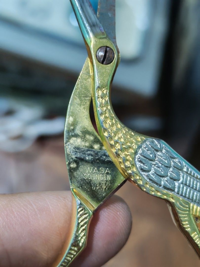 Wasa Solingen Crane Embroidery Scissors Gold Silver (Category: Craft Supplies & Tools) located in Manila. Submitted by GentleGiant (Listing ID 1460608023, Image 3). Description: - Vintage embroidery scissors - Made in Solingen, Germany - Unique crane embroidery design - Gold and silver finish - Blades show minor signs of age and use, still sharp and functional - Handle has some discoloration - Ideal for crafting or as a decorative accent.