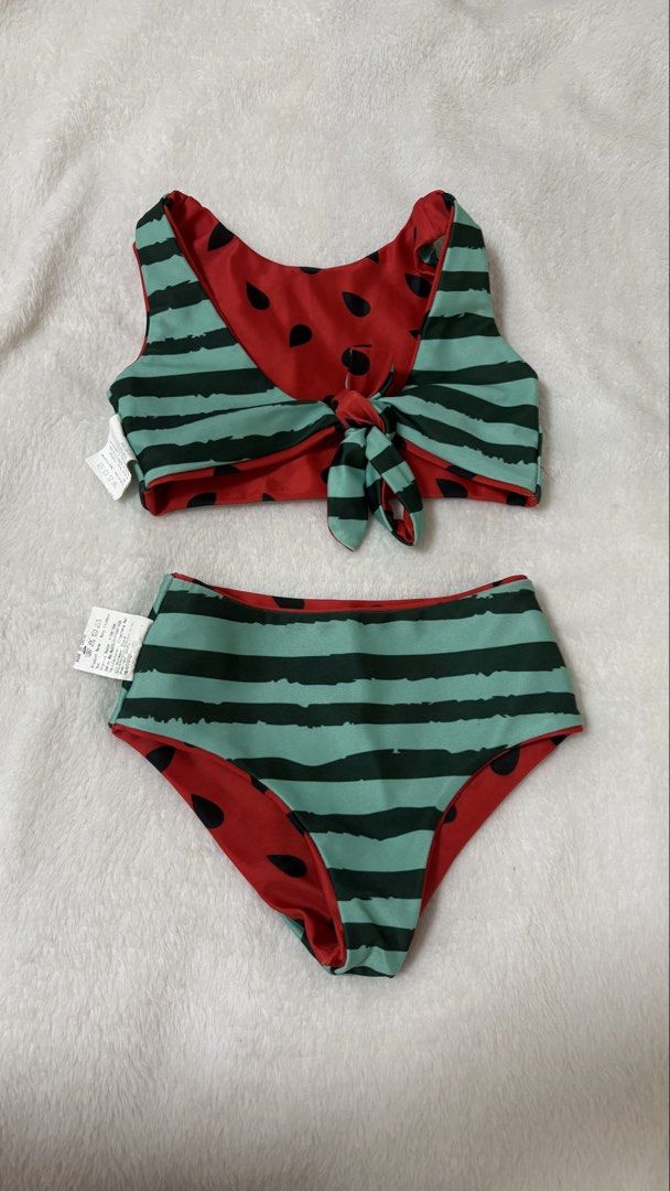Watermelon Reversible Bikini Set (Category: Babies & Kids Fashion) located in Manila. Submitted by valoisjama13821 (Listing ID 1460537384, Image 2). Description: - Adorable watermelon print bikini - Reversible design: watermelon print on one side, stripes on the other - Tie-front top for adjustable fit - Flattering high-waisted bottoms - Ideal for beach days, pool parties, and summer vibes.