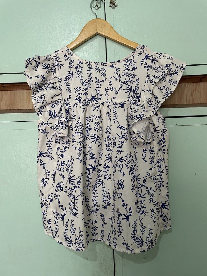 White and Blue Floral Print Flutter Sleeve Top (Category: Blouses) located in Mabalacat. Submitted by heybhaneyy (Listing ID 1460536320, Image 2). Description: - Cute white top - Blue floral print - Flutter sleeves for a flowy look - Light and breathable fabric - Easy to pair with jeans or skirts - Great for everyday wear or a day out.