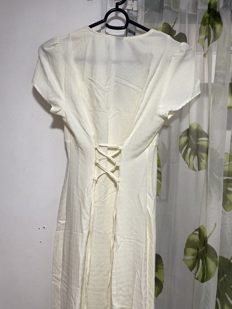 White Button-Front Midi Dress with Corset Back (Category: Dresses) located in Makati City. Submitted by eliza_gwen (Listing ID 1460550474, Image 3). Description: - White midi dress - Short puff sleeves - V-neckline - Button-down front - Corset lace-up detail at the back for adjustable fit - Textured fabric - Versatile for dressing up or down.